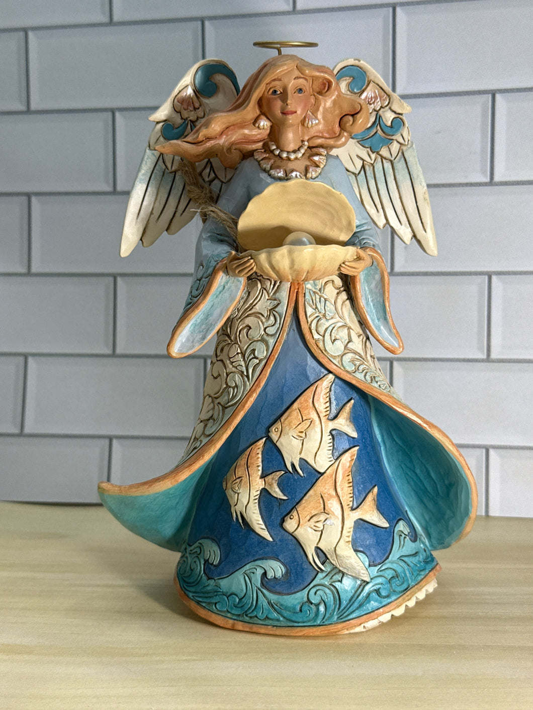 Angel Holding Shell